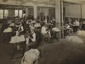 Workers with vision loss stitching mops (1930). Image credits: Byron Company (New York, N.Y.). Museum of the City of New York.
