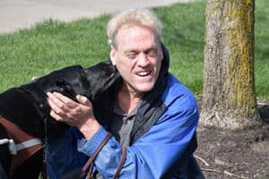 Alphapointe team member Hari with his guide dog, Vital