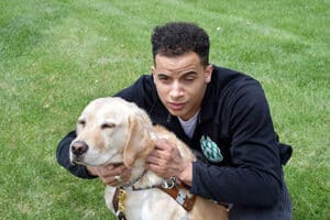 Alphapointe team member Devin with his guide dog, Ace