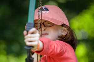 Horia shooting a bow and arrow at Adventure Camp