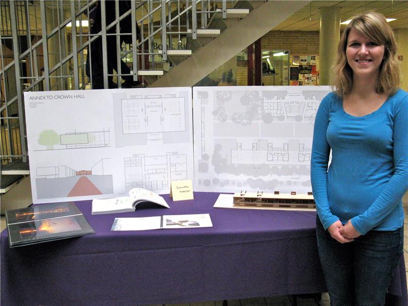 Sam with architectural drawings from a show she was in at K-State. 