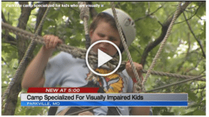 Screen shot of camper completing the ropes course during a KCTV-5 featurette