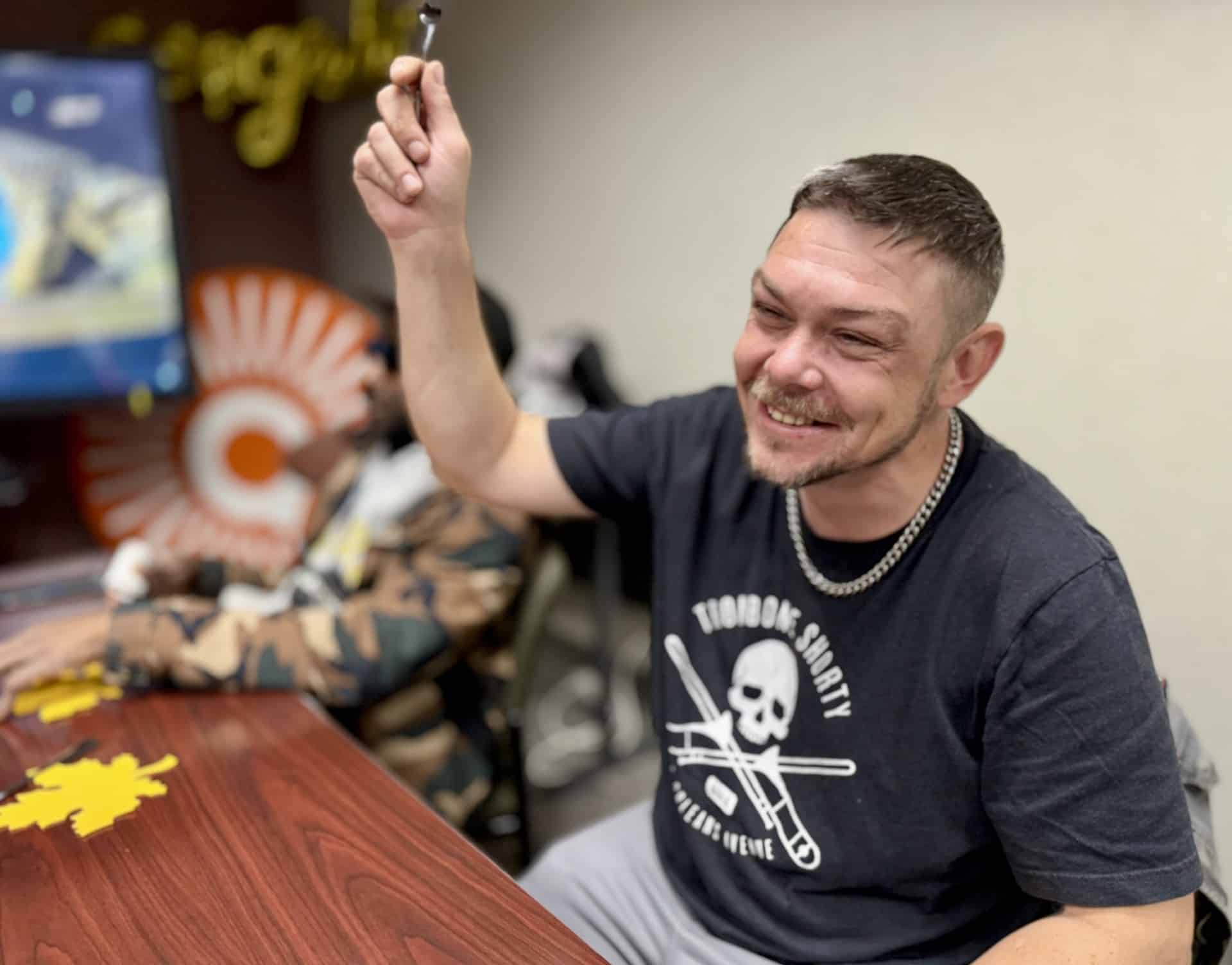 Ashton holds up a spoon during one of the games intended to help open up discussions.