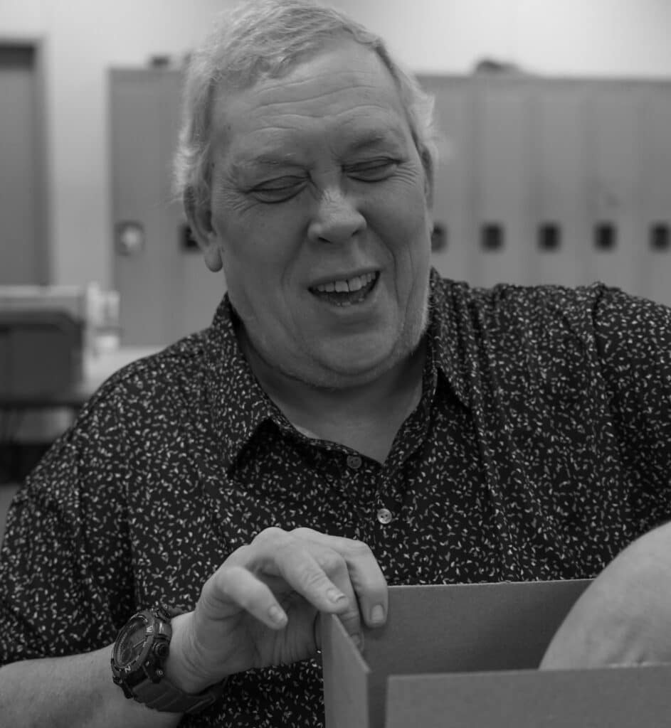 Three black and white pictures of Tom while working.