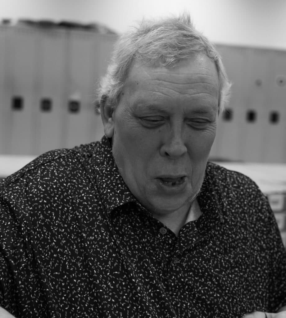 Three black and white pictures of Tom while working.